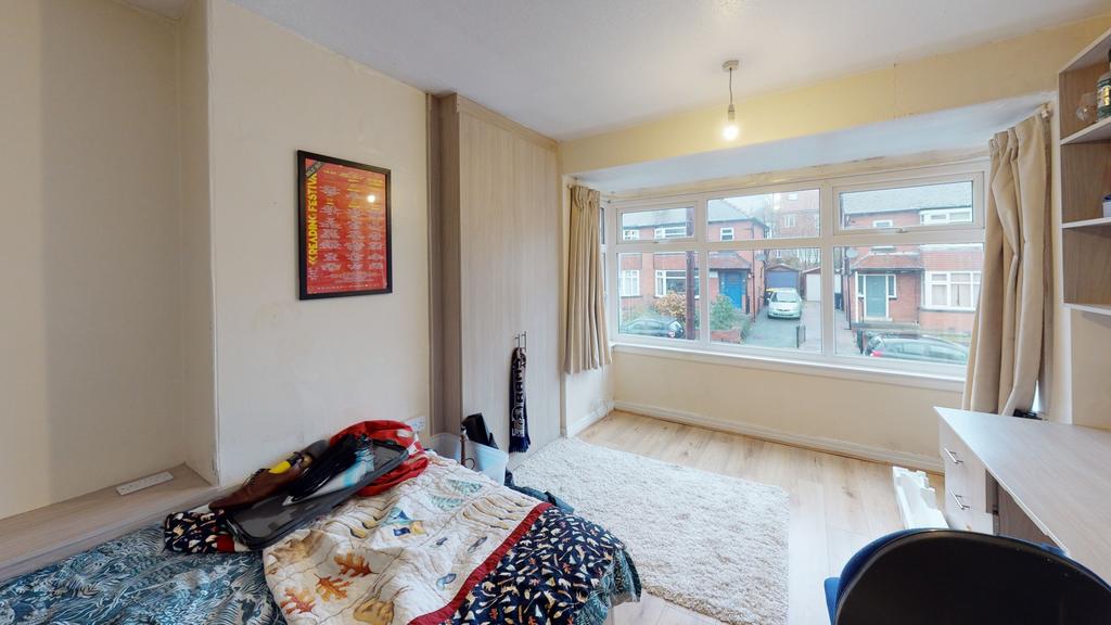 A bright and well-maintained bedroom featuring ...