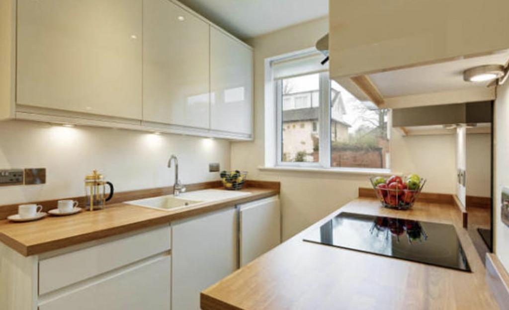 Bright and well-maintained kitchen with ample n...