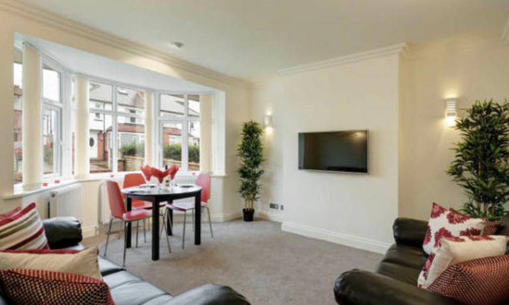 A bright and spacious living room featuring lar...