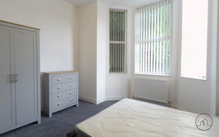 Bright and welcoming bedroom with large windows...