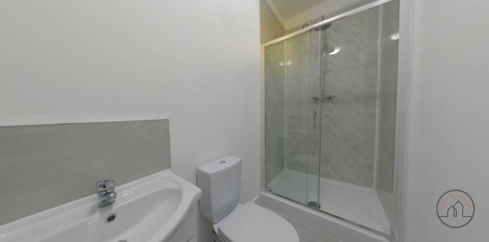 A clean and functional bathroom with a shower e...