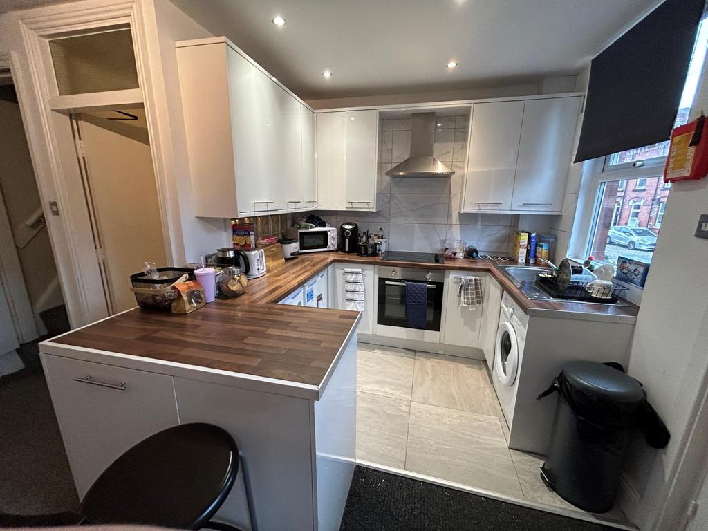 A well-maintained kitchen featuring white cabin...