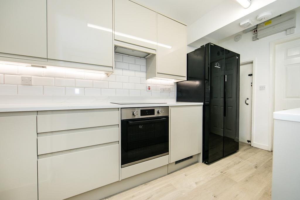 A modern, well-maintained kitchen featuring whi...