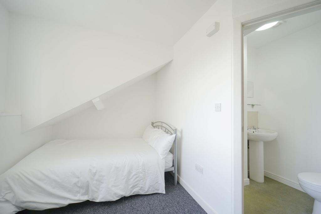 A clean and bright bathroom with a sink and toi...