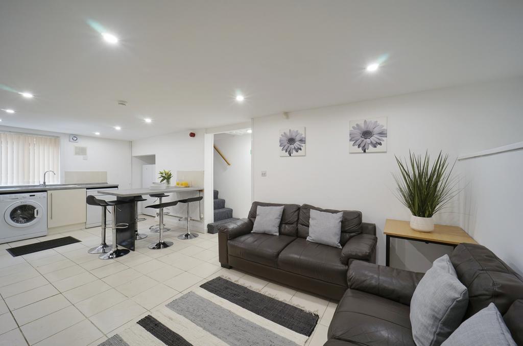 A spacious and modern living room featuring a c...