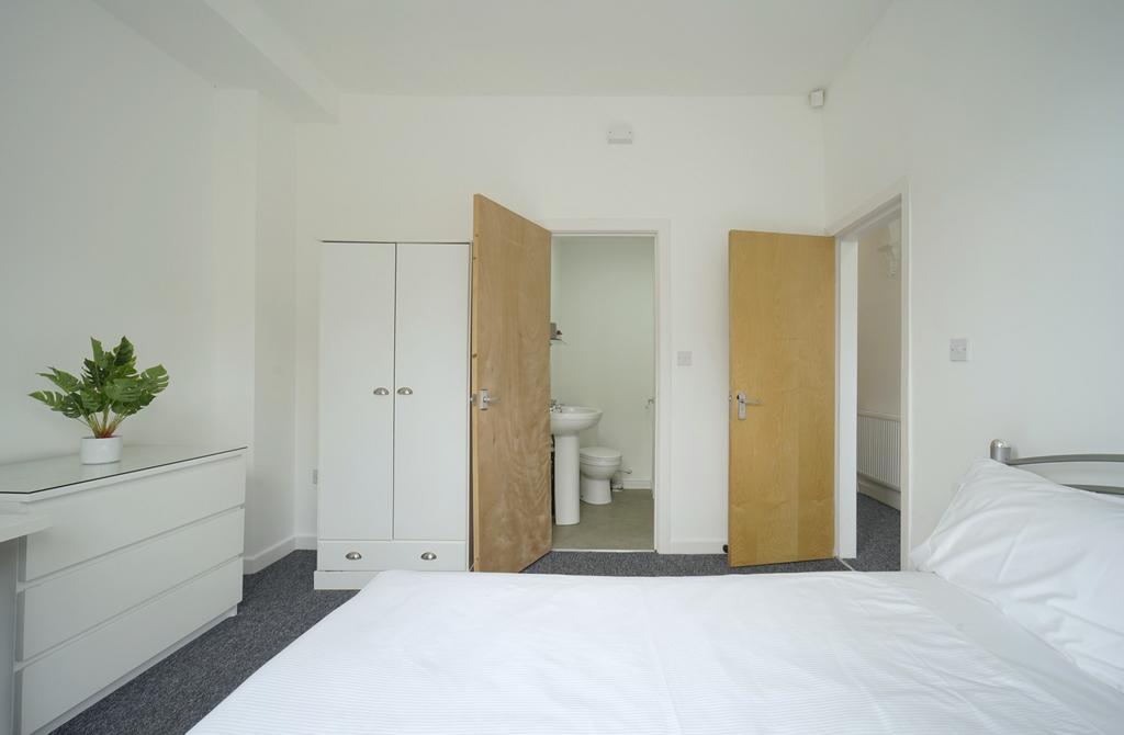 Bright and clean bathroom suite featuring a spa...