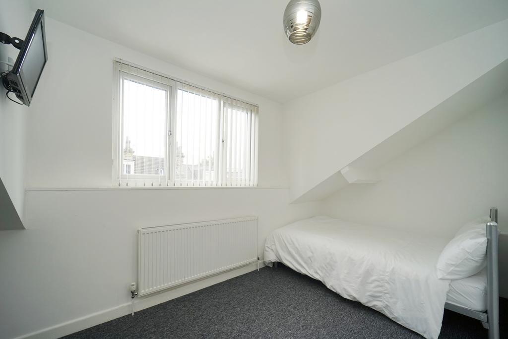 A bright and clean bedroom featuring a double b...