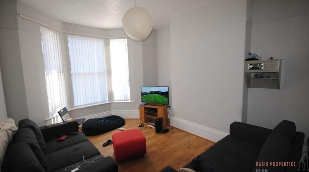 A bright and welcoming living room featuring na...