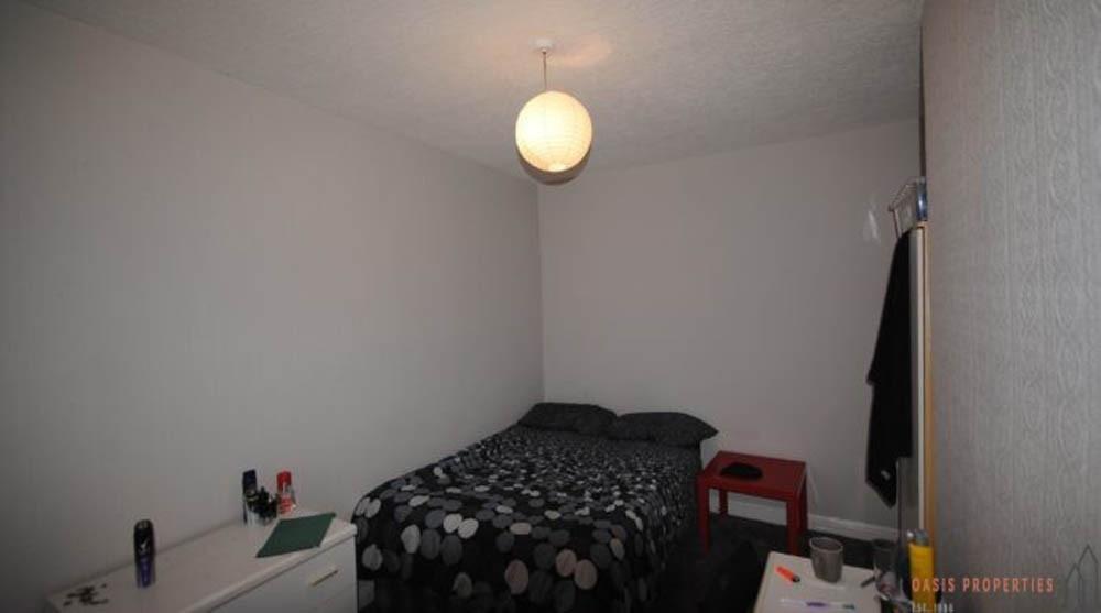 A cozy bedroom featuring a double bed with a bl...