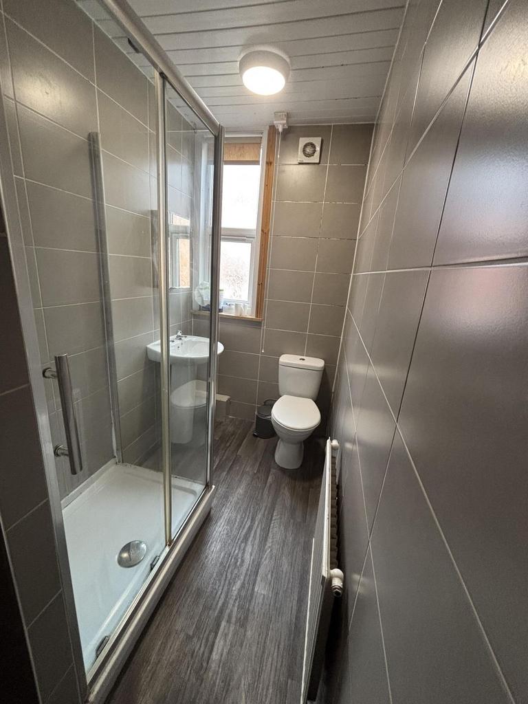 A bright and functional bathroom with a shower ...