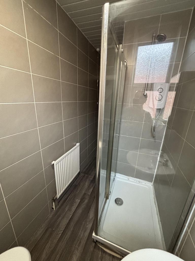 A modern, clean bathroom with neutral tiles and...