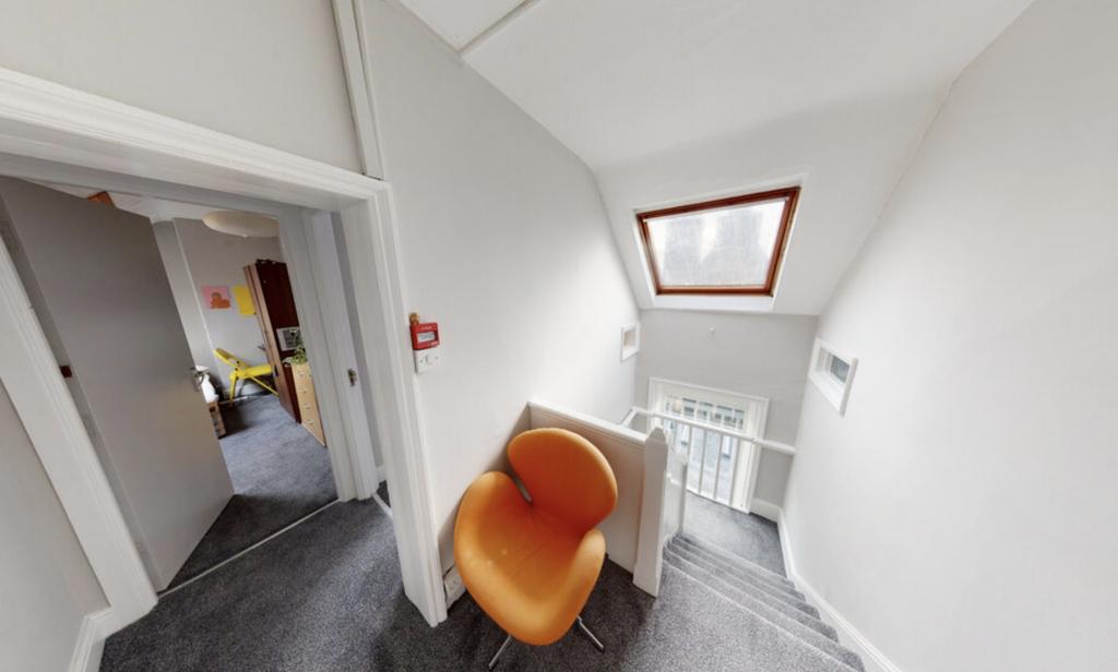 A compact, tidy room featuring a single toilet ...