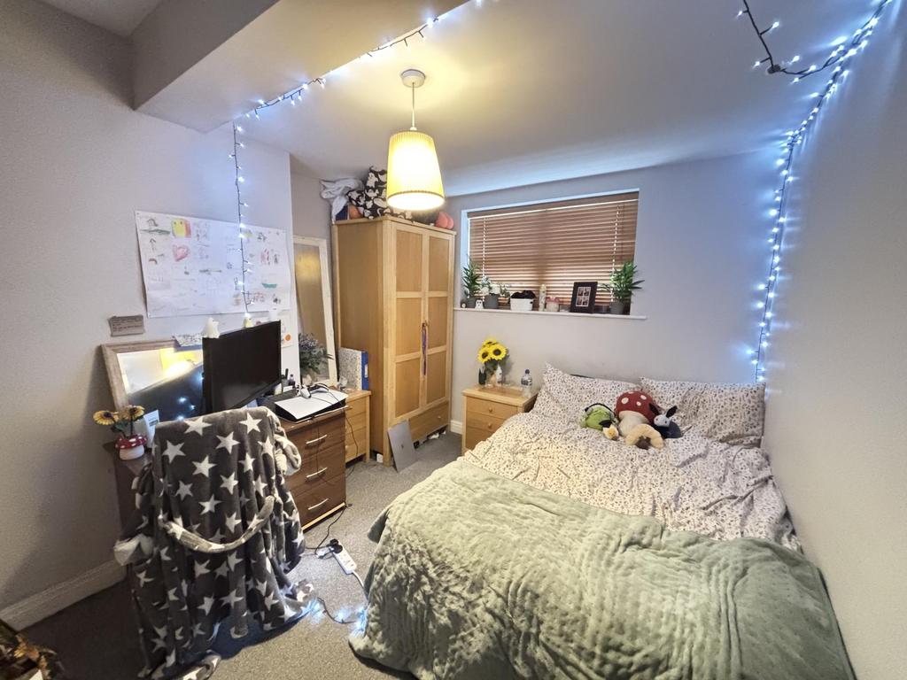 A cozy and inviting bedroom with soft lighting,...