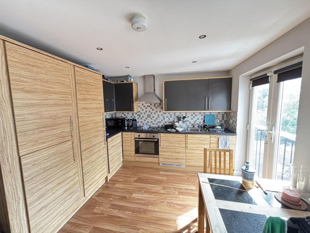 A modern, well-lit kitchen with ample natural l...