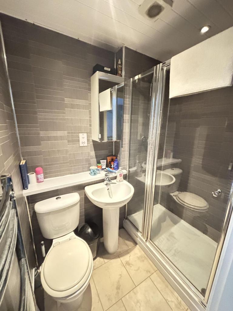 A clean and modern bathroom featuring a shower ...