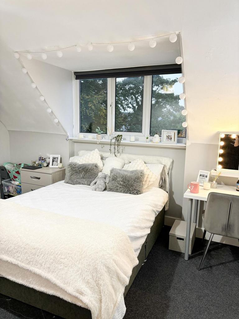 Bright and spacious master bedroom featuring a ...