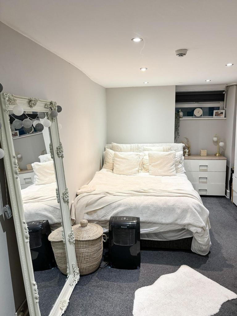 A bright and spacious master bedroom featuring ...
