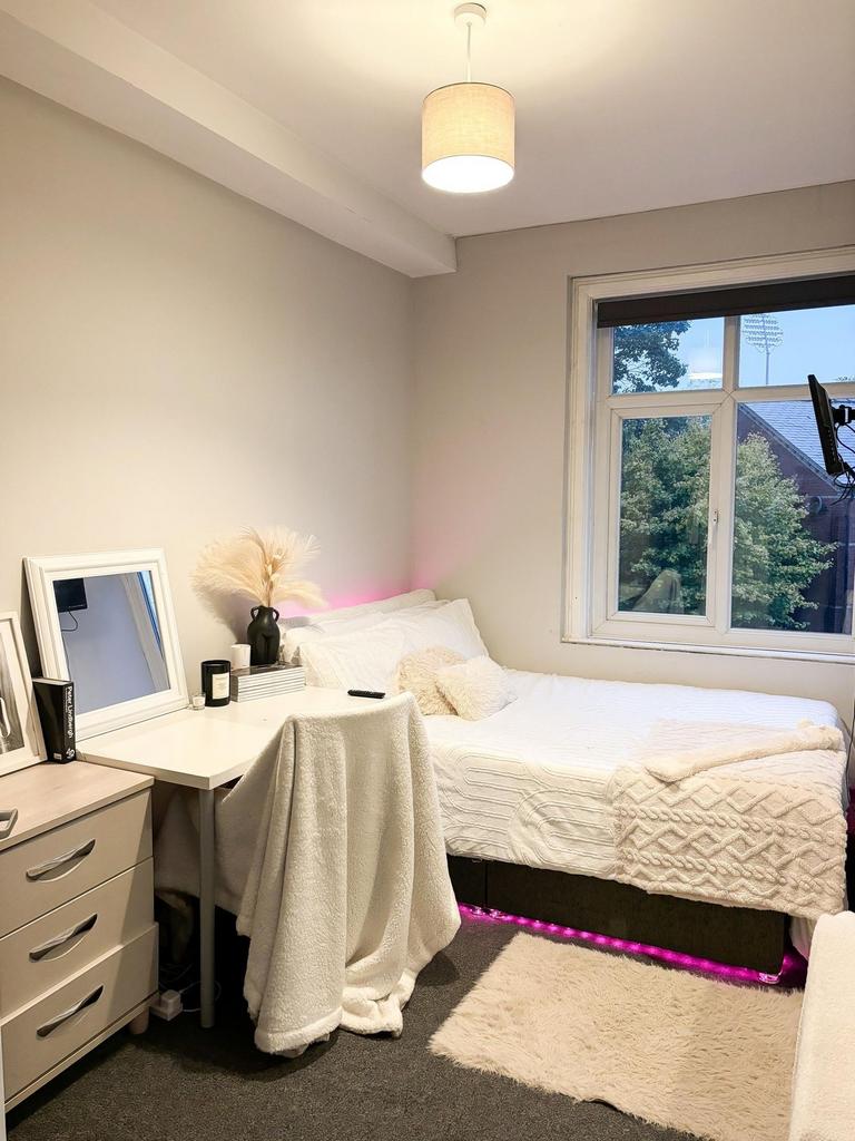 A bright and tidy double bedroom featuring a co...