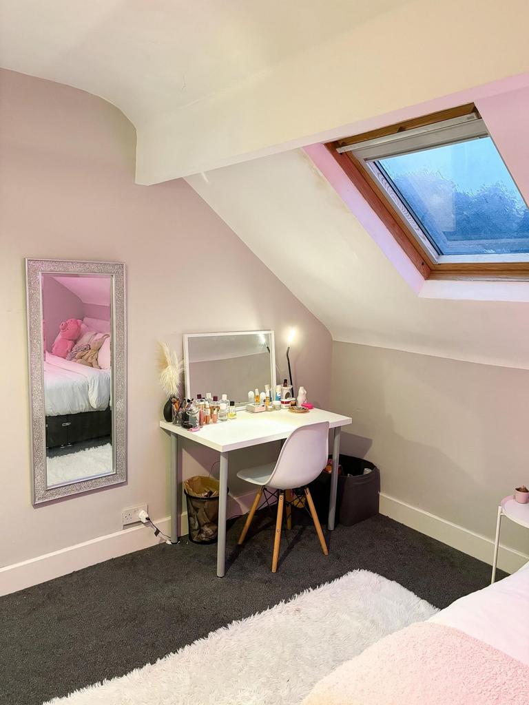 A cozy and well-maintained bedroom with a styli...