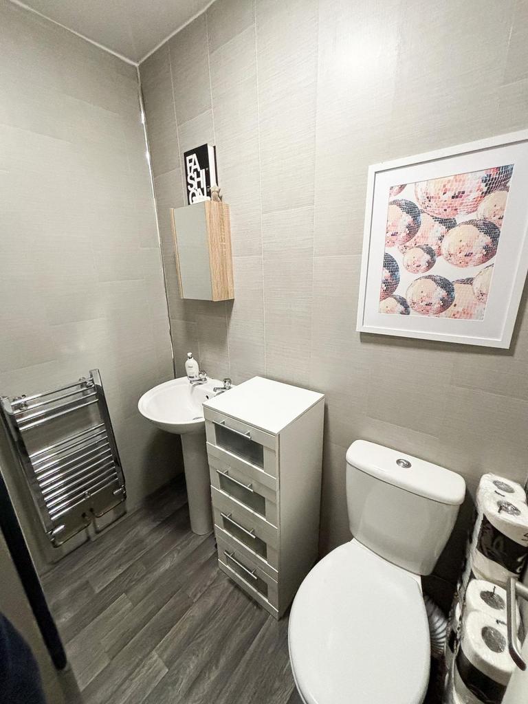 A modern, clean bathroom featuring a toilet, si...