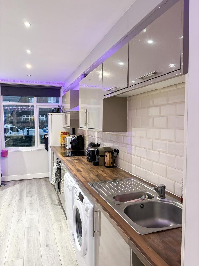A bright and modern kitchen featuring ample cou...