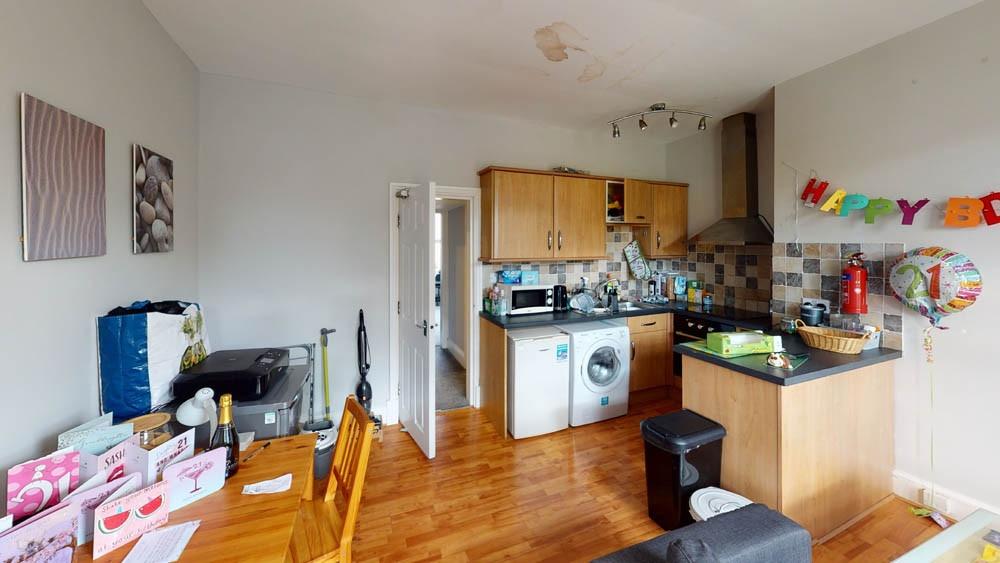 A bright and welcoming living room with ample n...