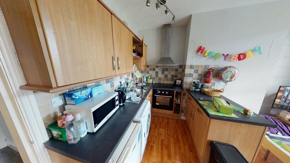 A well-kept kitchen area with ample workspace a...