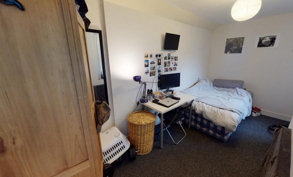 A cozy bedroom featuring a double bed with a st...