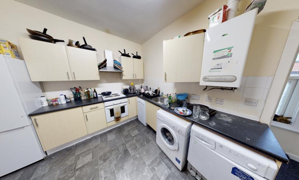 Modern and well-lit kitchen with ample counter ...