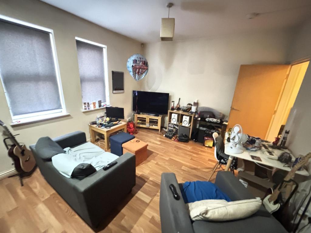 A spacious and well-lit living room featuring c...