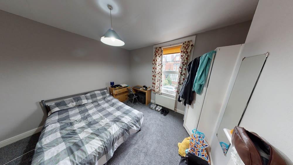 A cozy single bedroom featuring a comfortable b...