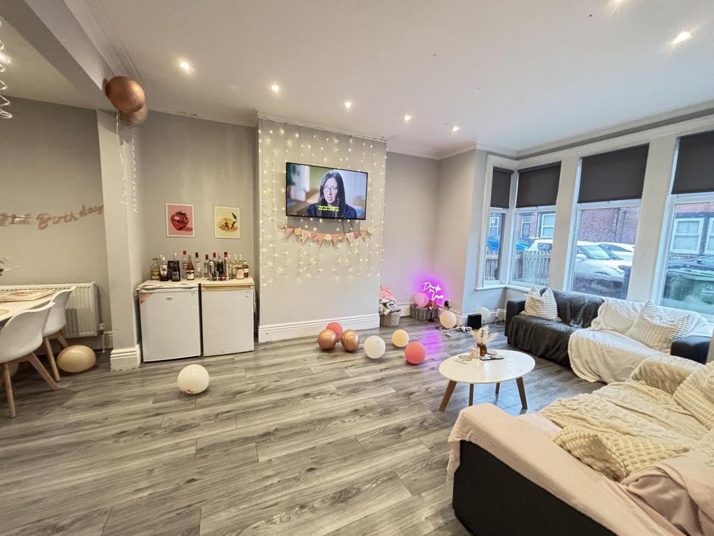 A spacious and modern living room featuring com...