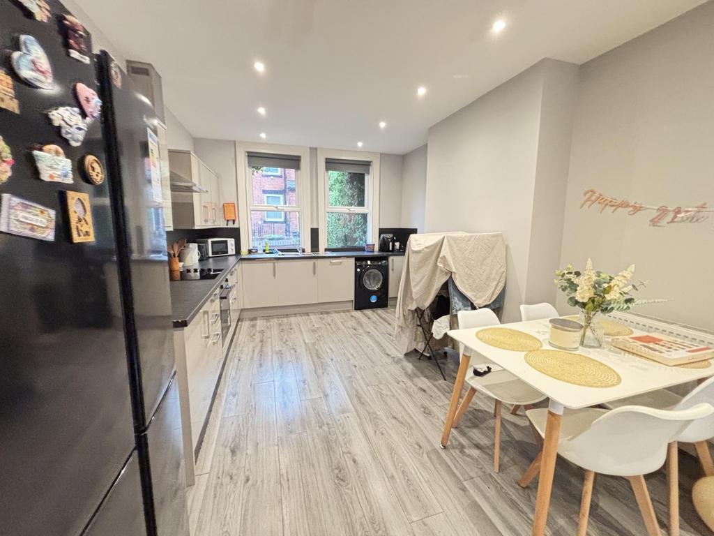 A bright and modern kitchen area featuring ampl...