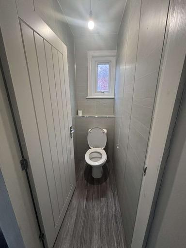 A clean and modern bathroom featuring a toilet ...
