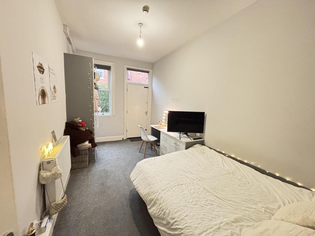 Bright, neatly presented bedroom with a comfort...