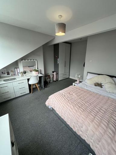 A bright and spacious master bedroom featuring ...