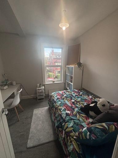 A bright and cozy master bedroom with a large b...