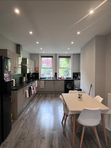 A bright, modern living room with large windows...