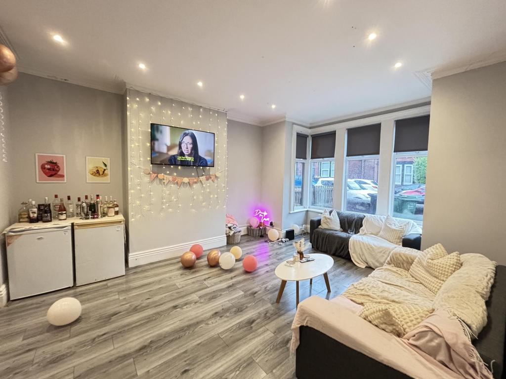 A bright and welcoming living room featuring mo...