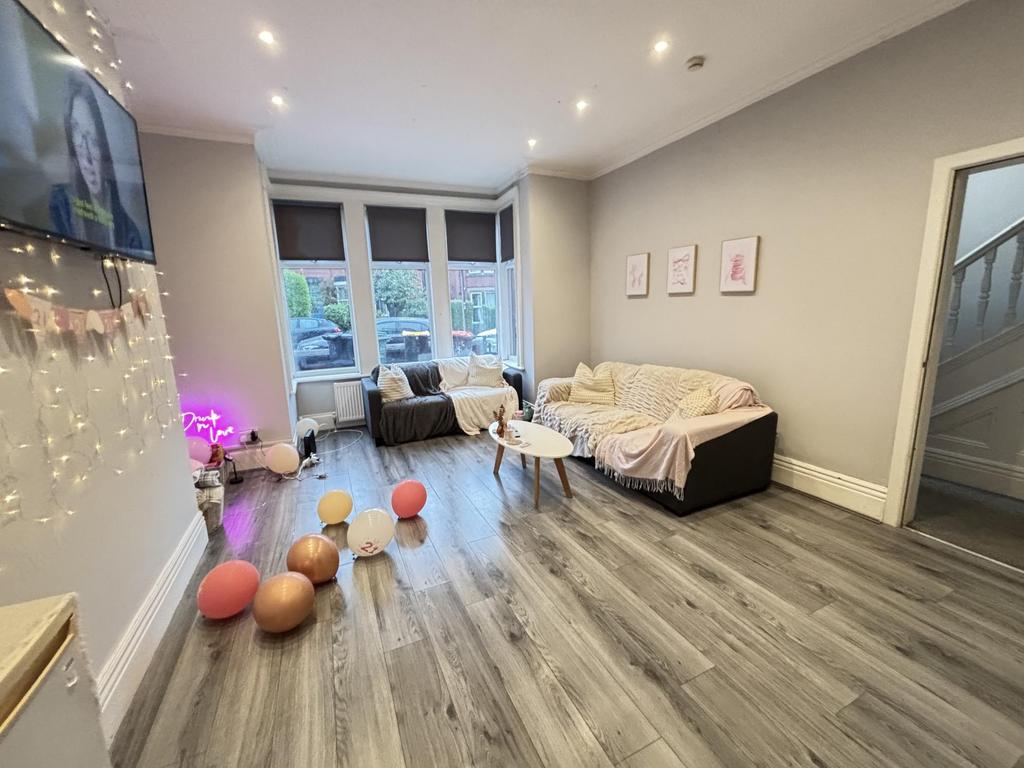 Bright and spacious living room with large wind...