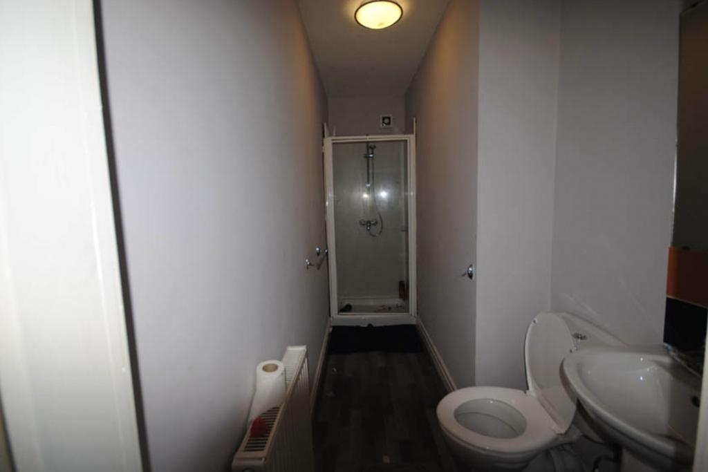 A clean and modern bathroom with a toilet, sink...
