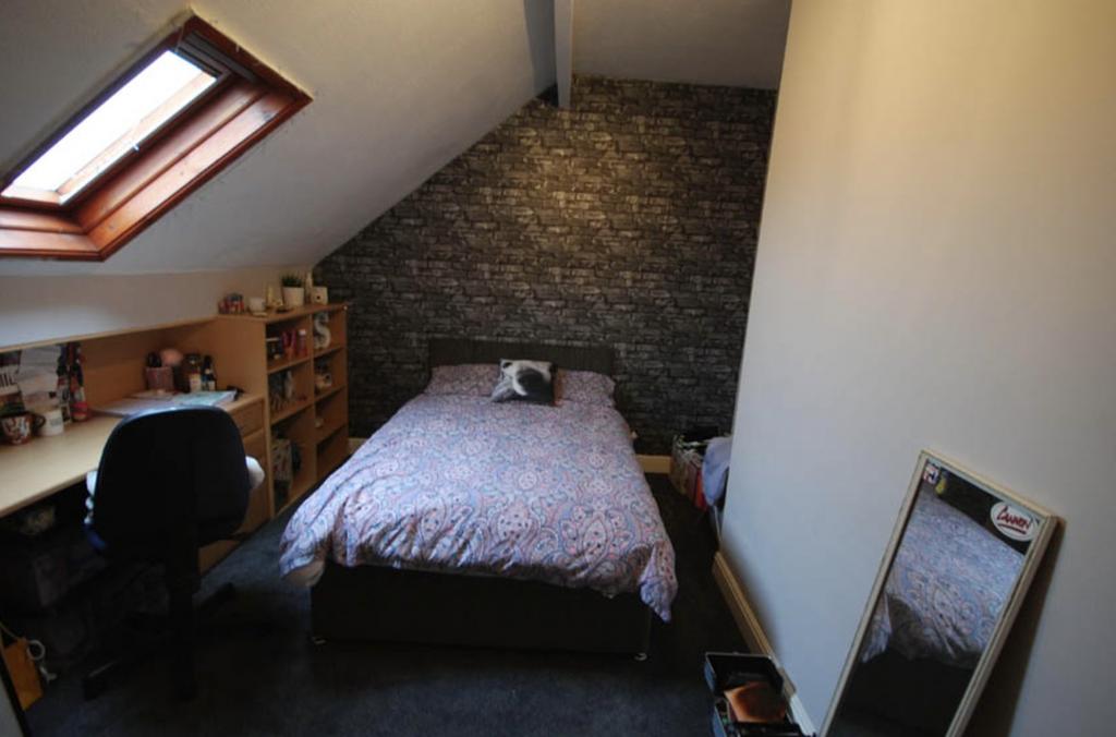 A cozy bedroom featuring a double bed with a st...