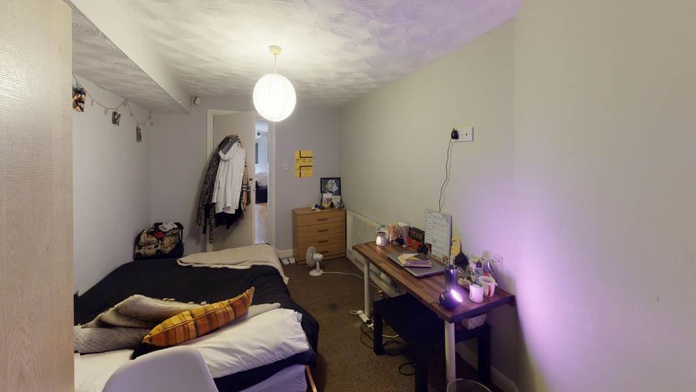 A cozy bedroom featuring a double bed with pill...