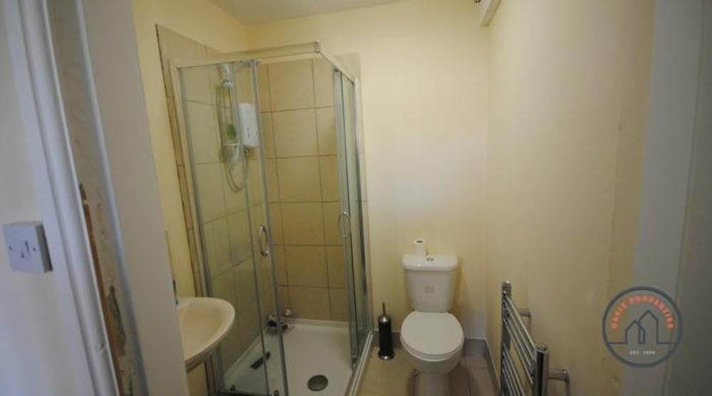 A well-maintained bathroom featuring a shower e...