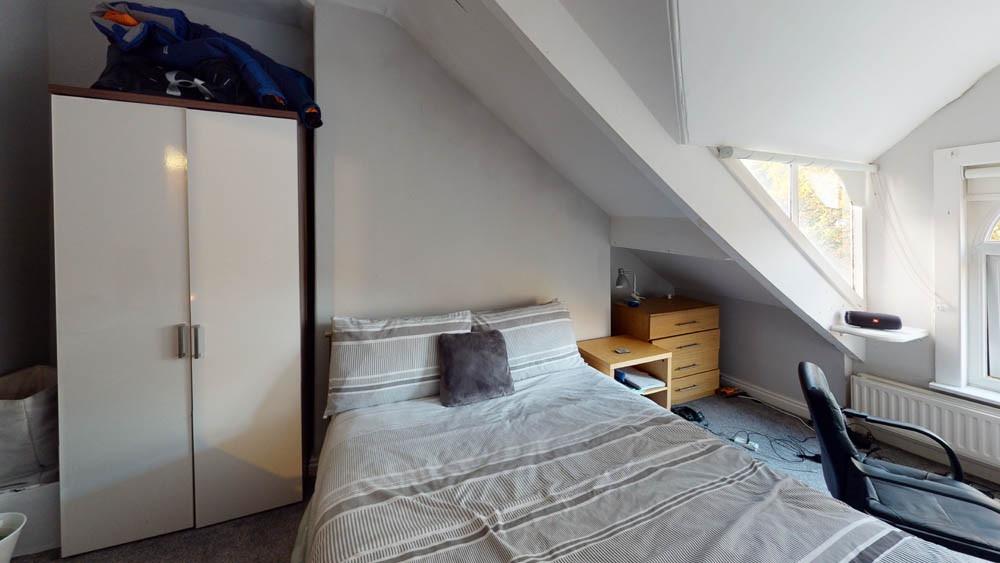 A tidy and bright single bedroom featuring a co...