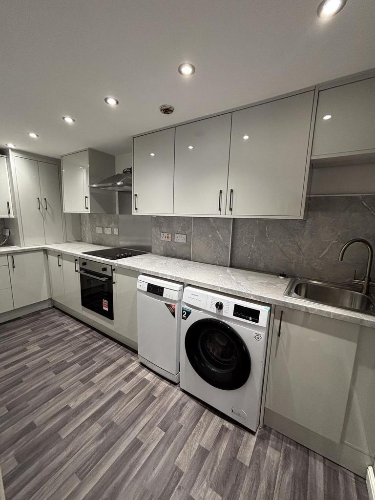 Modern, well-maintained kitchen featuring sleek...