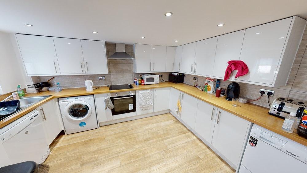 A modern, well-maintained kitchen with white ca...