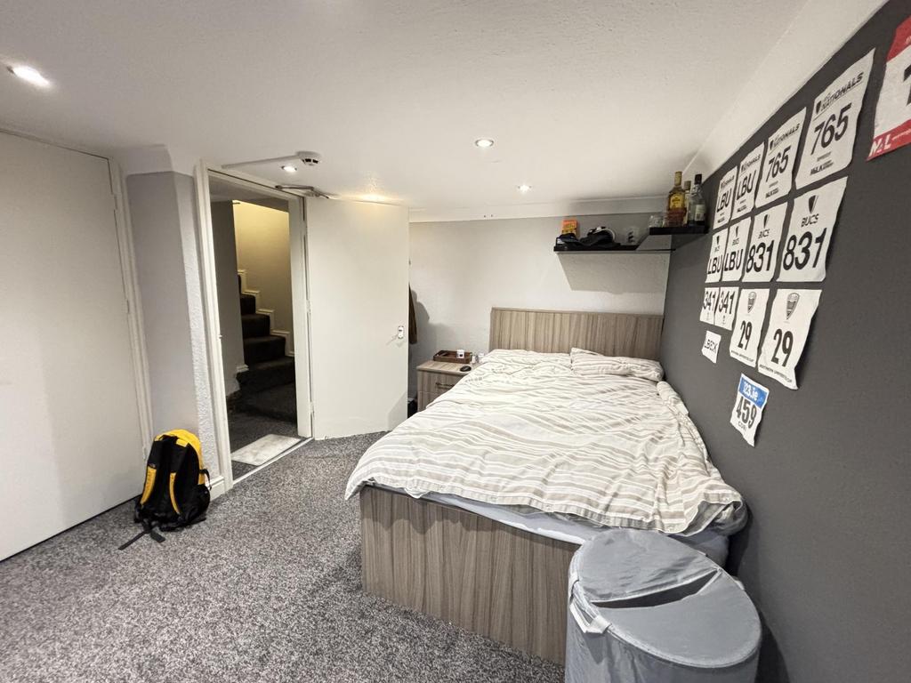 Spacious master bedroom with a comfortable doub...