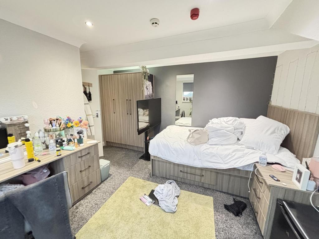 A spacious master bedroom featuring a large dou...
