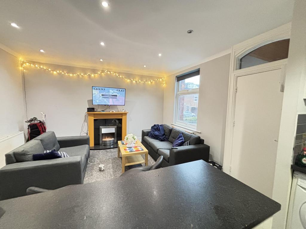 A bright and spacious living room featuring con...